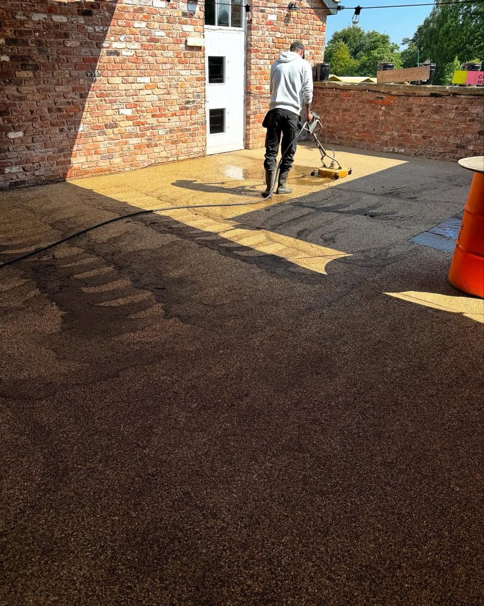 Skip The Work cleaning a resin driveway with a rotary surface cleaner